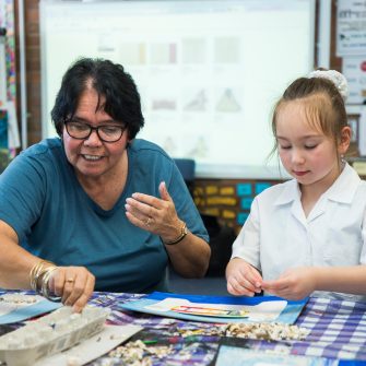 a girl  with Aunty Maxine making artwork