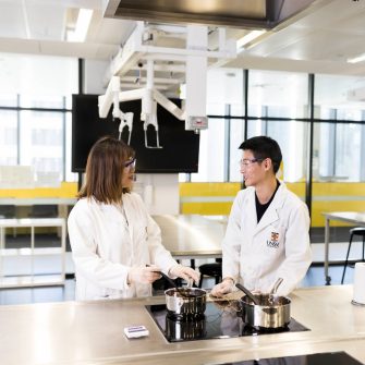 Two students in a food science lab