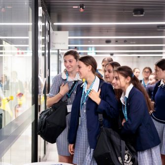 School students looking through glass