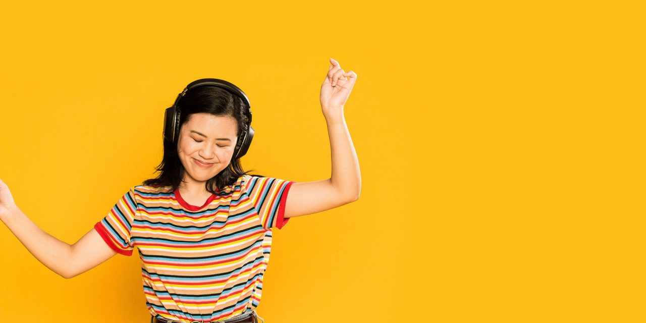 Student dancing with her headphones on