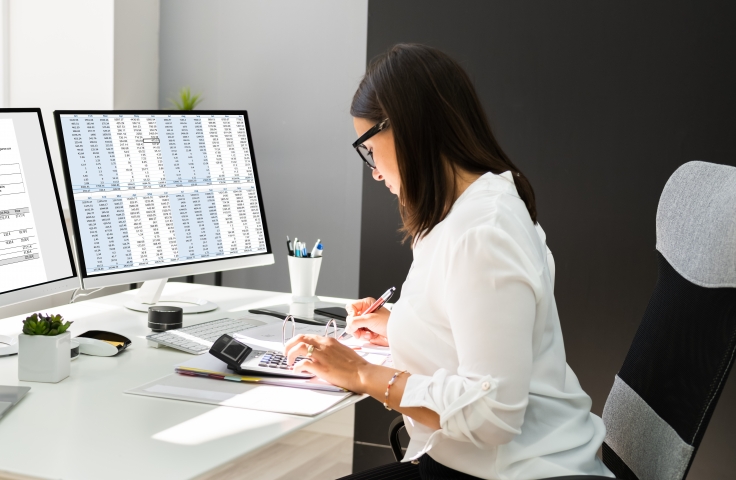 a woman working with computer and laptop