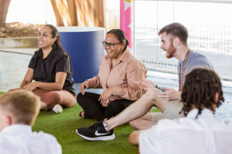 Adults sitting on floor talking
