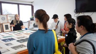 Young artists discusses printmaking with potential students