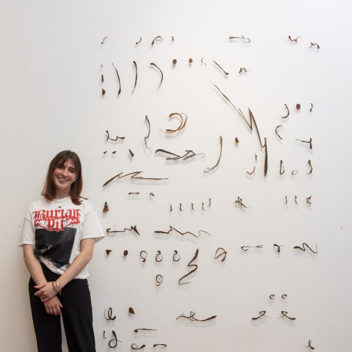 Tia Madden with their work Tia Madden, Some Sort of Notation (2024 - 2025). Oxidised mild steel and copper, dimensions variable.