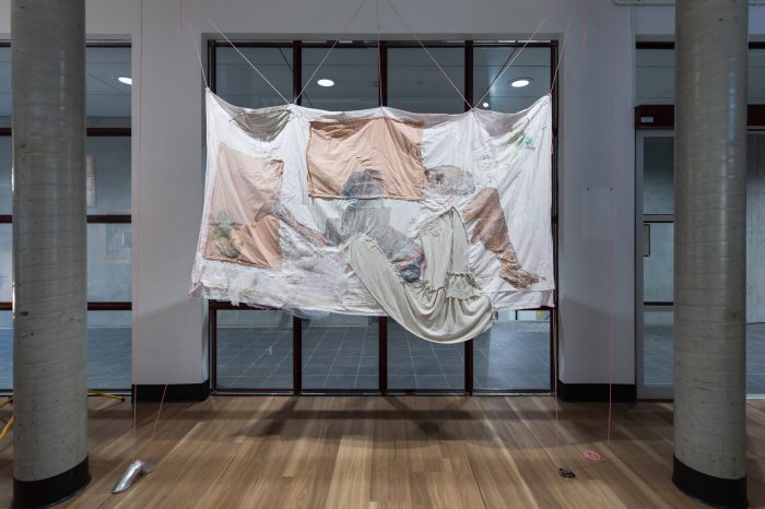 Trinity Johnson, ‘Dreaming of this’ (2025). Found and recycled fabrics and bedding, eucalyptus oil, acrylic medium, thread, beads, earthenware ceramics, 210cm x 165cm. Photograph: Anna Kucera.