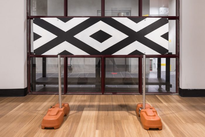 Allyson Brown, ‘Boundary St’ 2026. Wall mounted sign: Spray paint on metal, 50cm x 183cm. Triangle ‘give way’ sign: Acrylic and ochre on metal, 80cm x 80cm (80 cm each side). Free standing ‘authorised persons only’ sign: Acrylic and ochre on metal, 104cm x 93cm x 70cm.