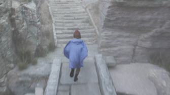 A character in a blue cape runs across a stone bridge towards stone stairs 
