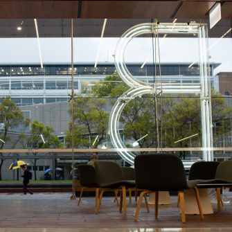 Photograph of the interior of the red centre built environment building located on the UNSW Kensington campus specifically focusing on the 'B' sculpture made of lights