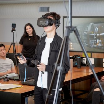 Students and teacher operate learning in a virtual reality cinema.