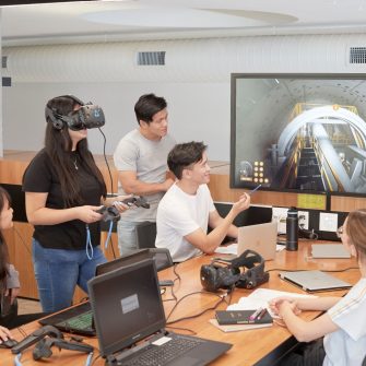 Students and teacher operate learning in a virtual reality cinema.