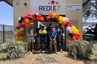 Collaborators stand outside the entrance of Bourke Community Garden