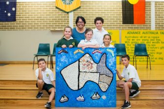 Aunty Maxine with students holding artwork at Chifley Public School