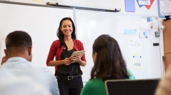 Teacher listening to students at an adult education class