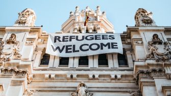 Building with 'refugees welcome' sign