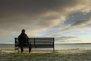 Elderly person sitting on a park bench