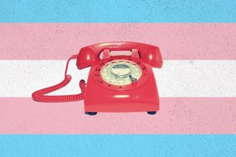 Red telephone on a pride coloured background