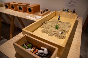 Workshop table with sand and figurines