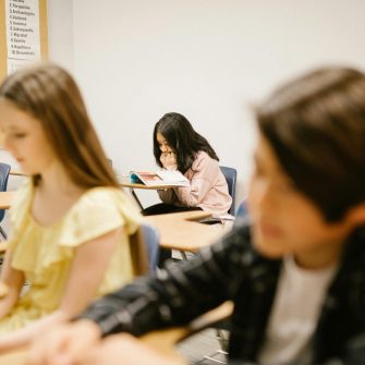 A scene of a school classroom depicting three 