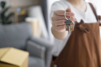 Crop close up of female tenant renter show praise house keys moving to first own new apartment or house, happy woman owner buy purchase home, relocate to dwelling, rental, rent, ownership concept