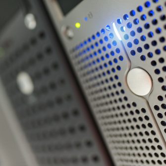 A close crop image captures data centre machinery, featuring led lighting.