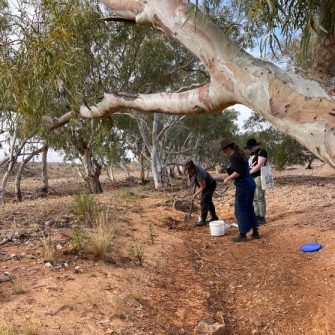 Students in the outback collecting different types of soil and rock 