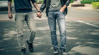 Cropped image of gay couple holding hands