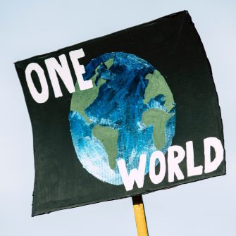 a banner with Earth planer saying one world