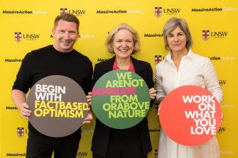 Prof Claire Annesley with Verity Firth and Kevin Finn holding up MC24 principles at the Massive Action Sydney Unconvention in March 2024 