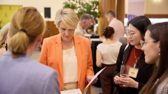 students with professor at a conference