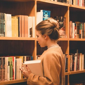 Woman searching for books in library