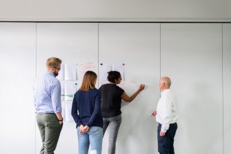 People standing in front of white board