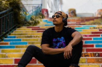 Photo of person listening to podcast on stairs