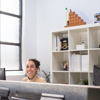 Woman smiling and working on her computer