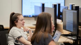 Students studying on computers in the business school computer lab.