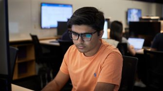 Students studying on computers in the business school computer lab.