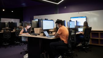 Students studying on computers in the business school computer lab.