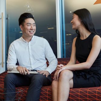 Post graduate students working on computers, talking and studying at the business school, Kensington UNSW