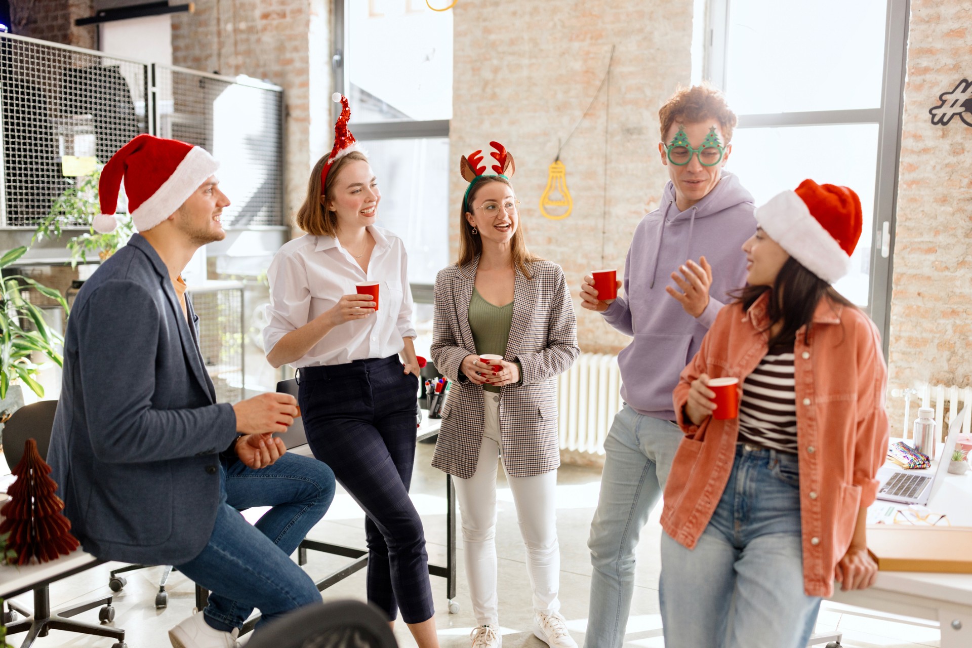 Young creative people are celebrating holiday in modern office.