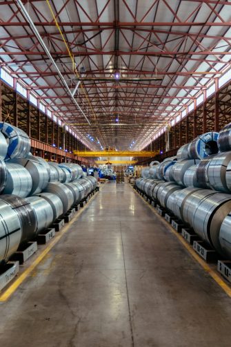 Rolls of galvanized steel sheet inside the factory or warehouse.