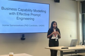 Iromie Samasarasekara gives her presentation in front of a screen.