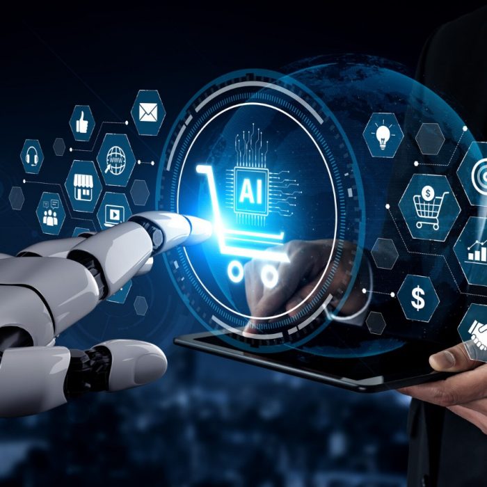 A robot hand reaches toward AI business technology icons held by a businessperson, representing AI in business.