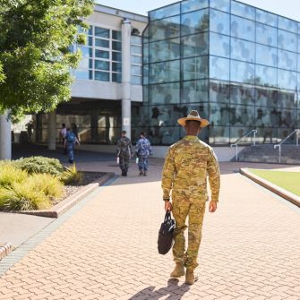 ADFA Canberra UNSW army student with bag walking towards building