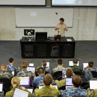 ADFA Canberra UNSW lecturer and students with laptops in lecture room