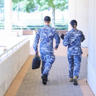 Two people in uniform from the back