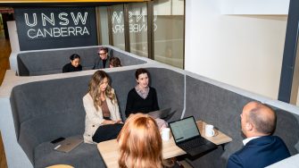 UNSW Canberra employees sitting in a booth