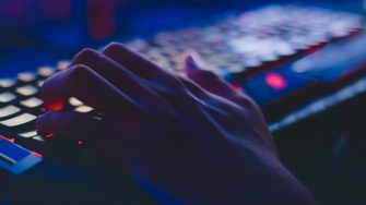 Hand on a keyboard in darkness