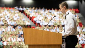 Student in military uniform presenting to audience