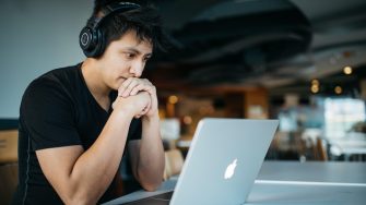 Man with headphones working on laptop