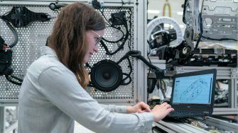 Woman in engineering lab working on laptop