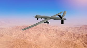 MQ military drone flying over desert on the Middle East